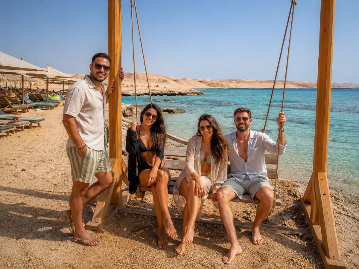 Friends on the beach swing at Magawish Island with the desert mountains and turquoise Red Sea in the background, Hurghada